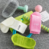 Eine Sammlung farbenfroher Yoga- und Fitnesssocken, darunter eine grau strukturierte Matte sowie rosa, weiße und limettengrün
