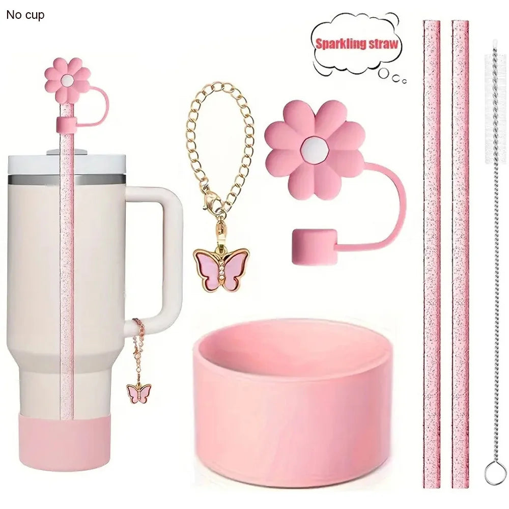 A set of six reusable accessories for a tumbler includes a pink tumbler, a sparkling straw, a flower charm, and a pink cup.