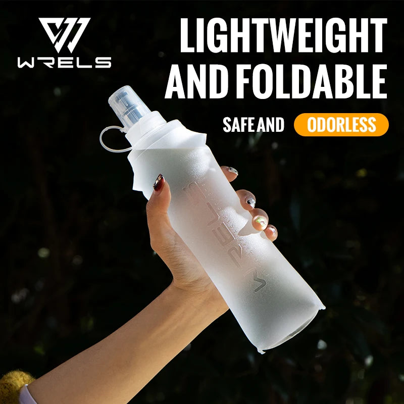 A hand holds a clear, lightweight and foldable silicone hydration flask with a white cap against a dark background.