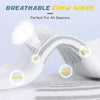 Close-up of white breathable crew socks rolled and displayed on a surface.
