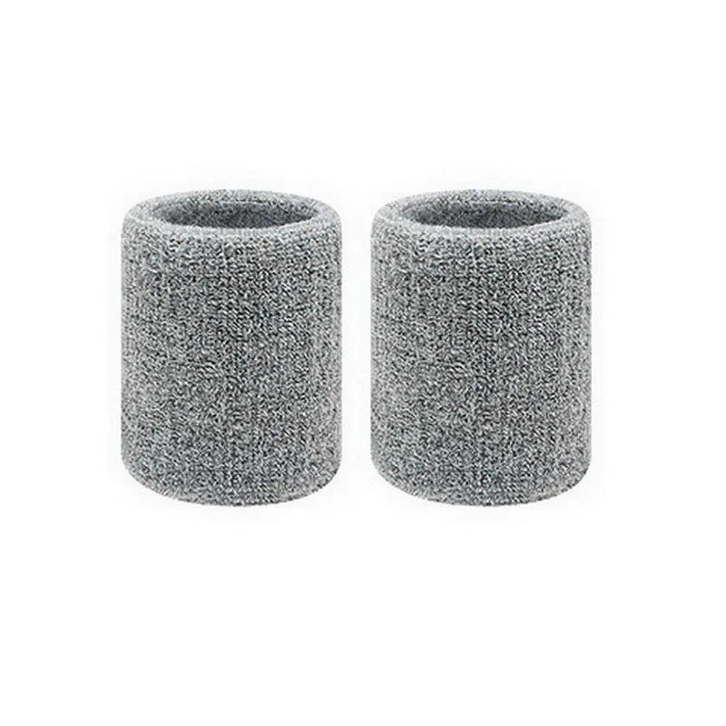 Pair of gray dual sports wristbands designed for sweat absorption.