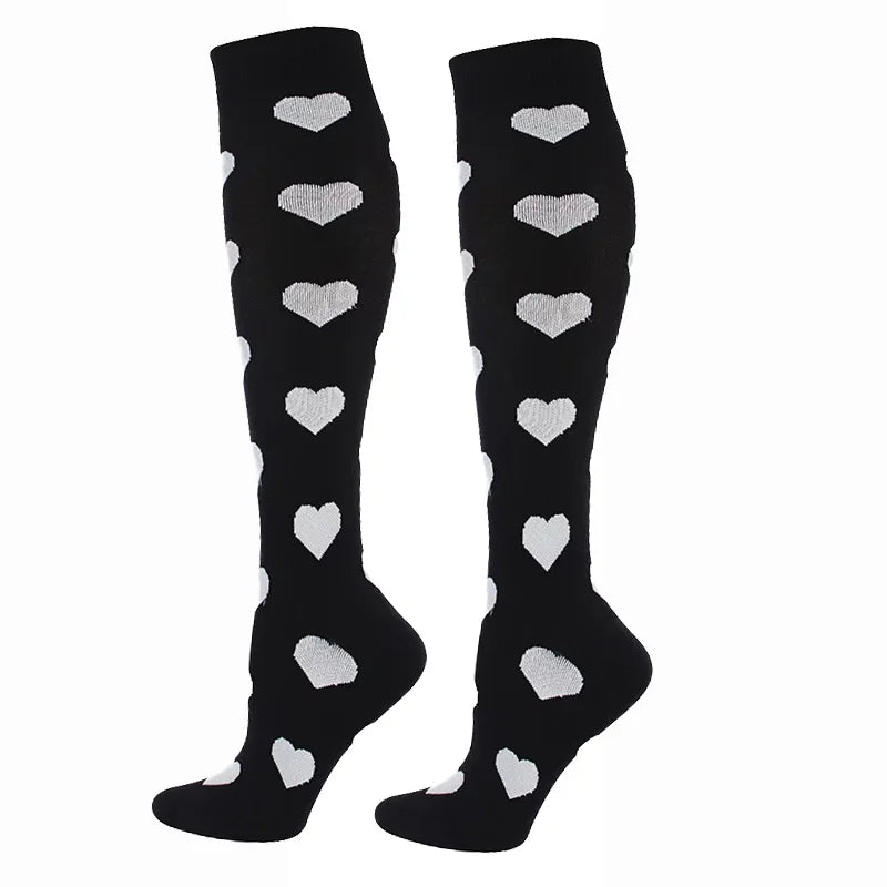 Pair of black compression elastic socks decorated with white heart patterns