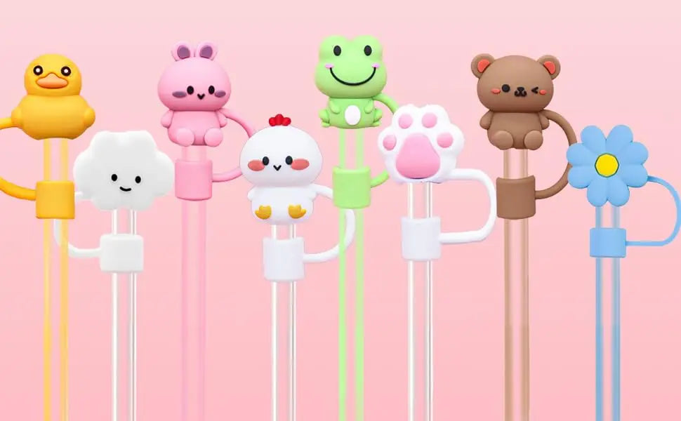 A collection of colorful silicone straw covers shaped like animals, including a duck, a rabbit, a frog, a bear, and a flower.