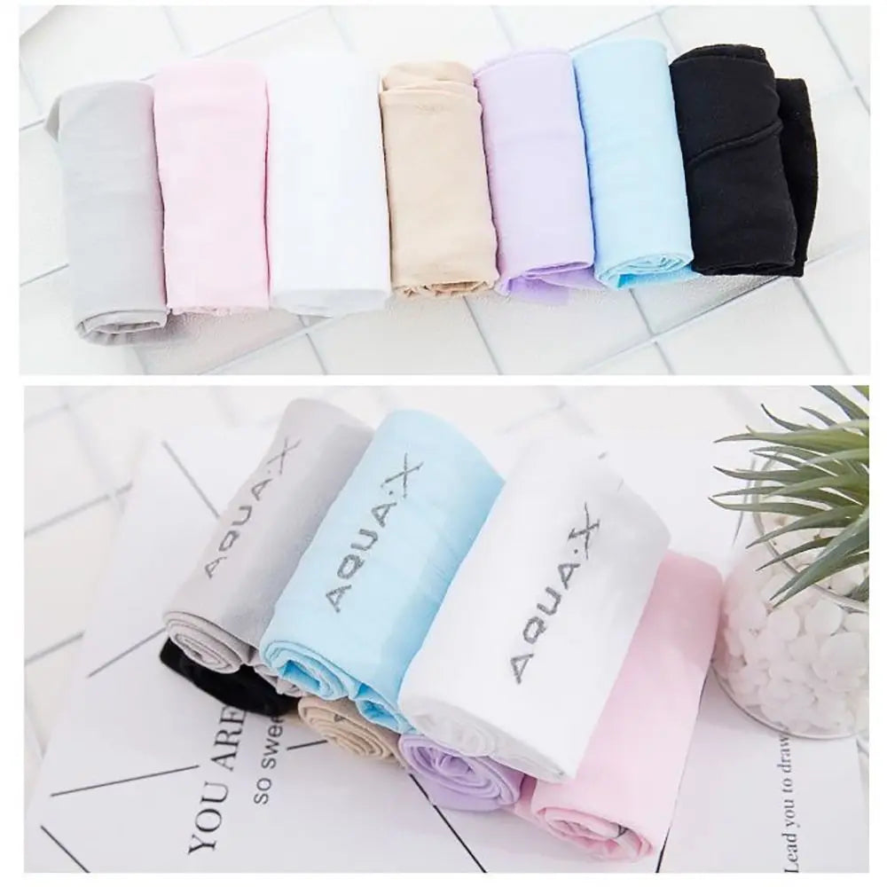 A collection of rolled arm sleeves in various pastel and dark colors laid out on a white surface.