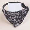 Black and white patterned adjustable pet scarf for dogs and kittens with a white tag.