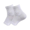A pair of white therapeutic compression socks for foot and ankle pain relief.