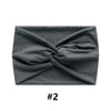 A gray fabric headband tied in a criss-cross knot.