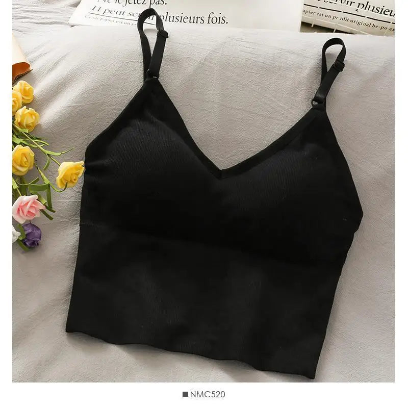Black off-shoulder camisole tank top for women displayed on a light fabric.