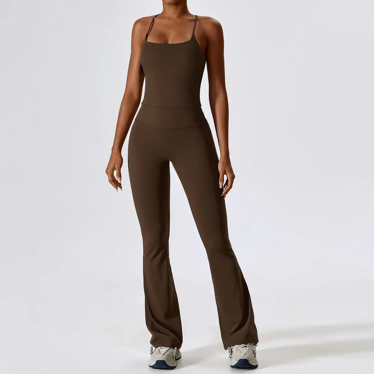 A woman wearing a dark brown women's performance tracksuit set.