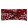 A burgundy fabric headband with white bohemian paisley print folded and tied