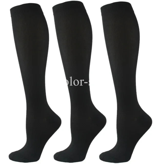 A set of three black compression socks for athletes and medical use