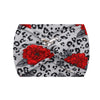 A gray fabric headband featuring a leopard print pattern and large red floral accents.