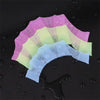 A stack of silicone swim training flippers in pastel pink, yellow, and light blue colors.