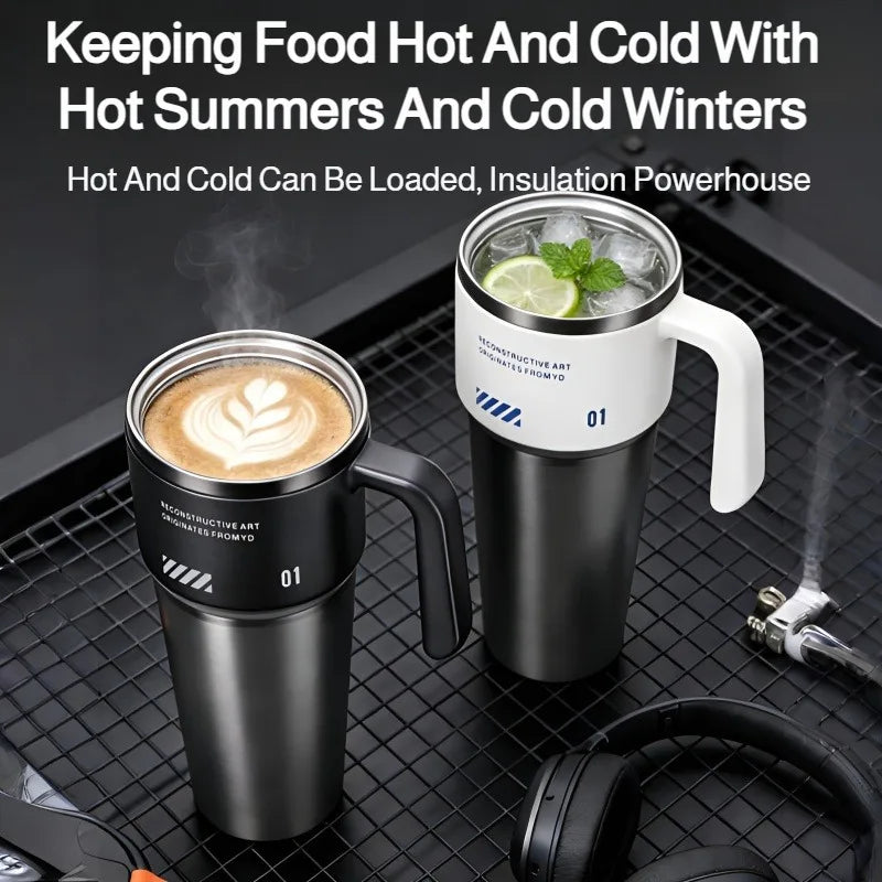 A black insulated stainless steel tumbler filled with ice and a lime slice sits on a black mesh tray.