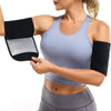 A woman is wearing sweat shaper arm trimmers on her arms while exercising.