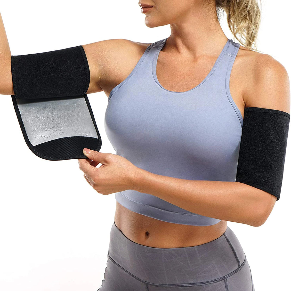 A woman is wearing sweat shaper arm trimmers on her arms while exercising.