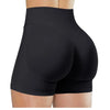 Black high-waisted yoga shorts worn by a person from the rear view.