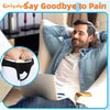 A man is shown wearing an inguinal hernia support belt while relaxing and using a laptop.