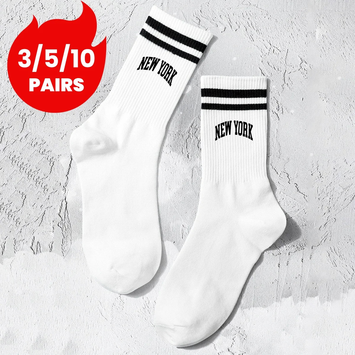 A pair of white crew socks with black lettering that reads NEW YORK, displayed on a textured background.