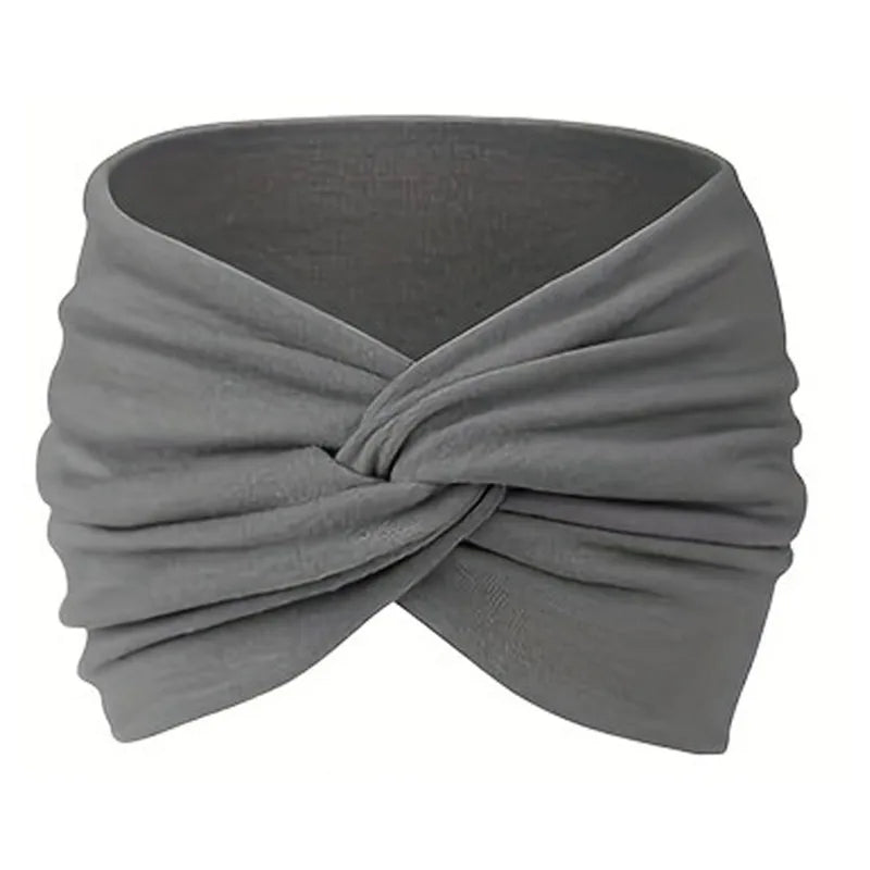 A gray stretch sport headband tied in a crisscross knot for hair and workout