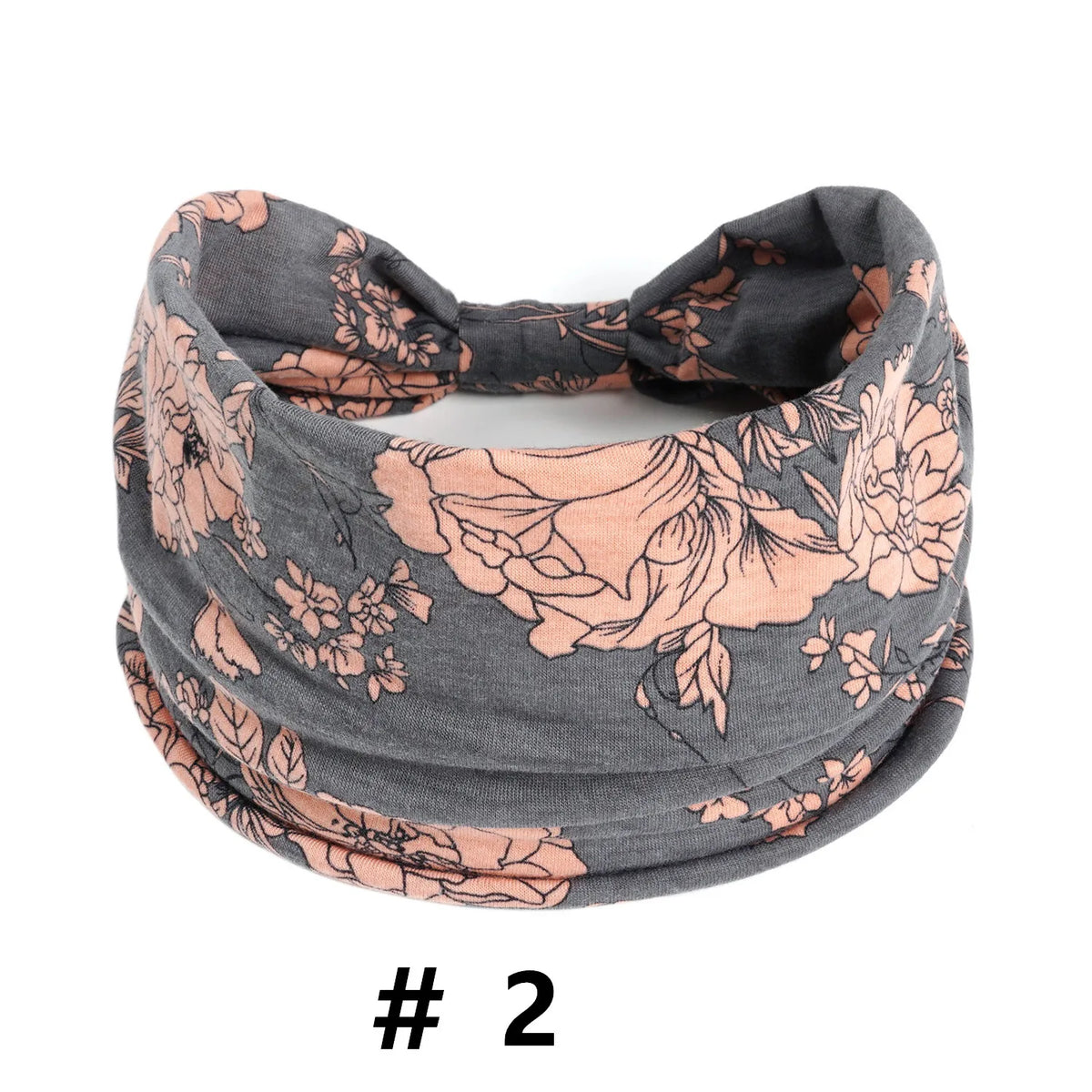 Un bandeau en tissu gris avec un imprimé floral dans des tons pêche et vert doux.