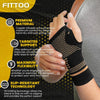 A hand wearing a black copper-infused nylon wrist protector for support and comfort.