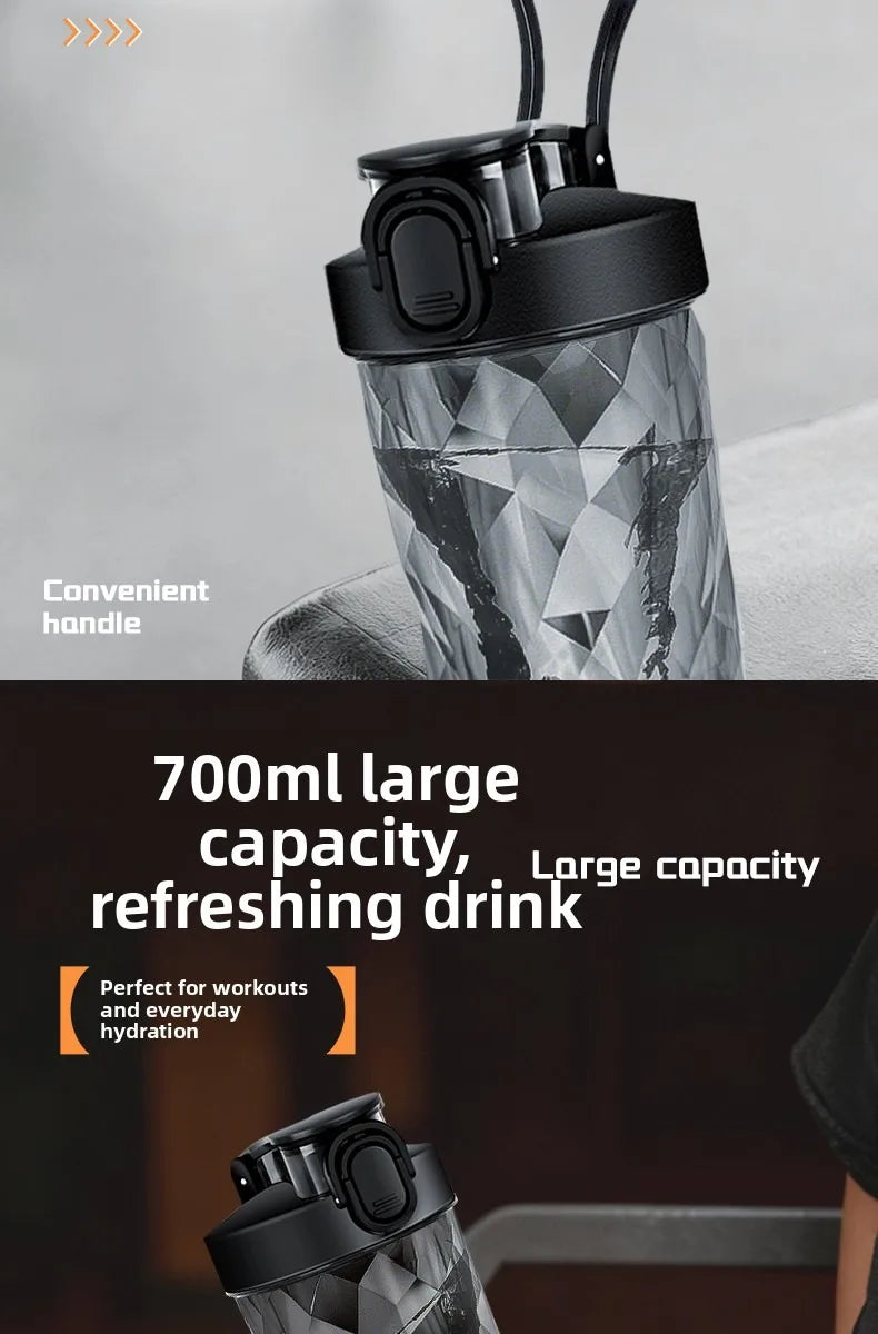 A close-up shot of a black portable electric shaker bottle with a transparent, faceted body, showing its convenient handle.