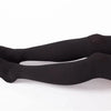 Black compression thigh high socks worn on a person's leg.