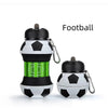 A black and white football-shaped water bottle with a silicone cap and attached by a metal clip.