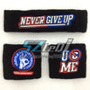 Two black embroidered cotton sports wristbands featuring 'NEVER GIVE UP' and 'USE ME' text.