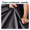 A hand is demonstrating the tear-resistant and sturdy nature of a black leather fabric.