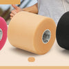 Three rolls of pink, beige, and black athletic foam tape are shown next to a person's hand.
