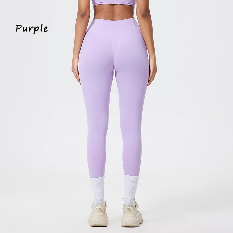 Lila, nahtlose Yoga-Leggings mit hoher Taille, getragen von einem Model, kombiniert mit weißen Socken und hellen Sportschuhen