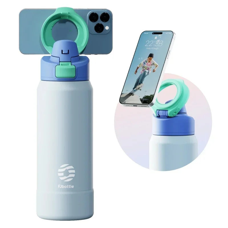 A light blue insulated sports water bottle with a magnetic lid and a matching silicone carrier ring.