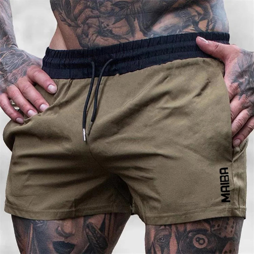 A close-up of men's olive green stretch performance drawstring shorts being held by a hand.