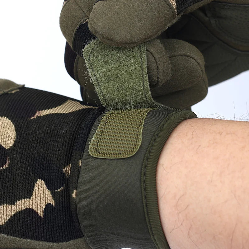 A close-up of a hand wearing olive green full finger mitts with black and tan patterned wrist protection.