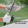 A hand wearing cross silicone palm anti-slip design gloves is holding a fishing rod over green water.