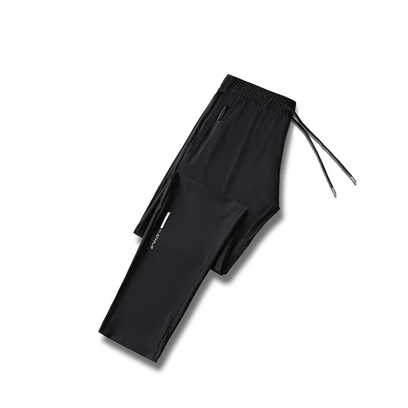 Black men's ice silk performance pants laid flat with drawstring visible