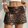 A woman models a brown and black leopard print casual mini skirt with a white crop top.