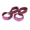 A pair of maroon gym wrist wraps for strength training.