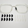 Clear plastic eyeglasses with black silicone anti-slip nose pads and spare clear nose pads.