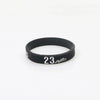 Black silicone wristband with the number 23 printed on the face