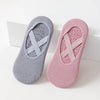 Pair of non-slip yoga and gym socks with silicone grip in gray and pink.
