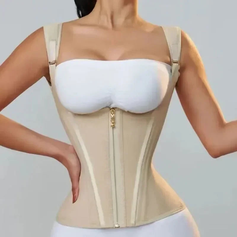 A model is wearing a beige adjustable body shaper corset vest top with a zipper closure.