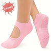 A pair of pink non-slip Pilates yoga socks shown on a person's foot.