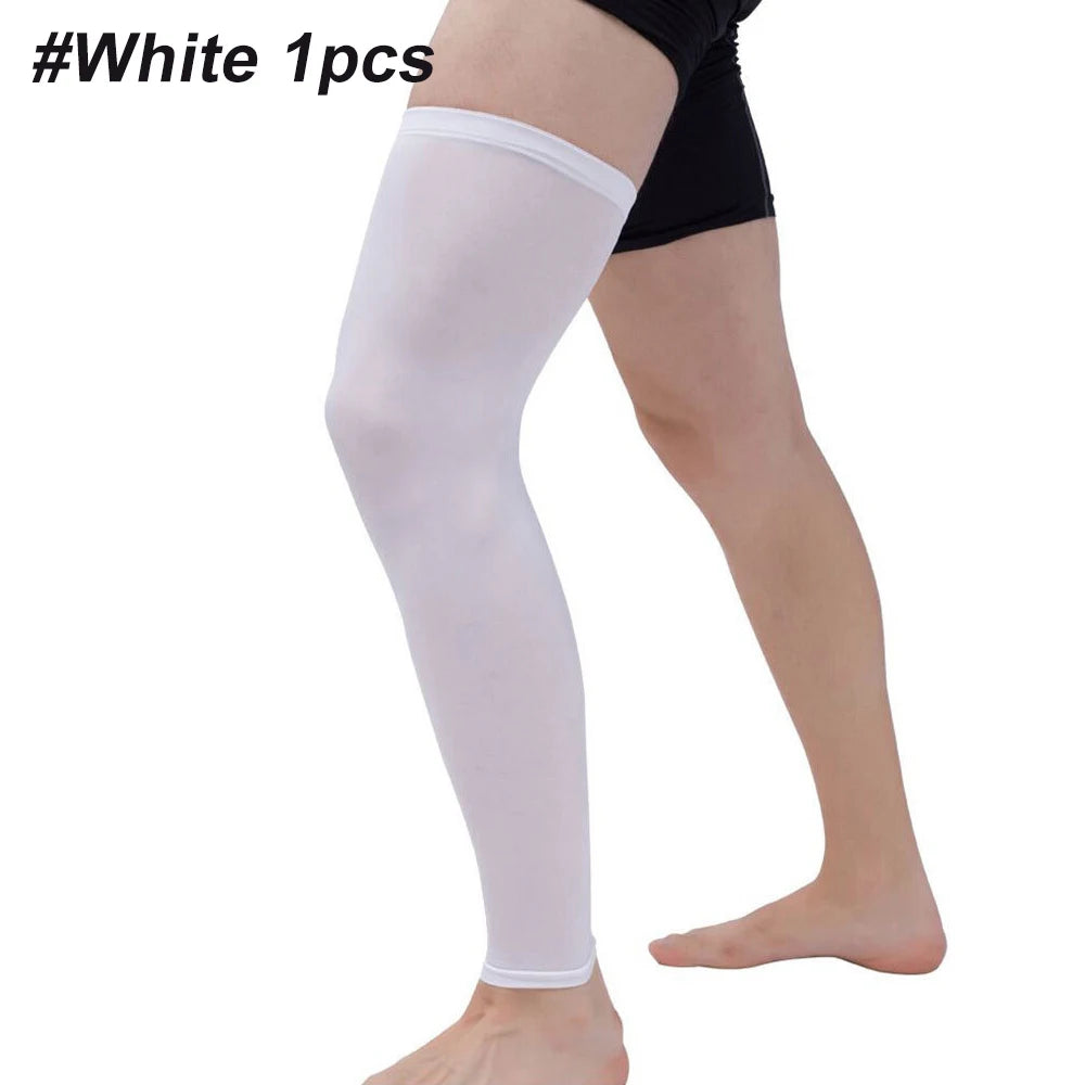 A person wearing white compression leg sleeves on their lower legs.