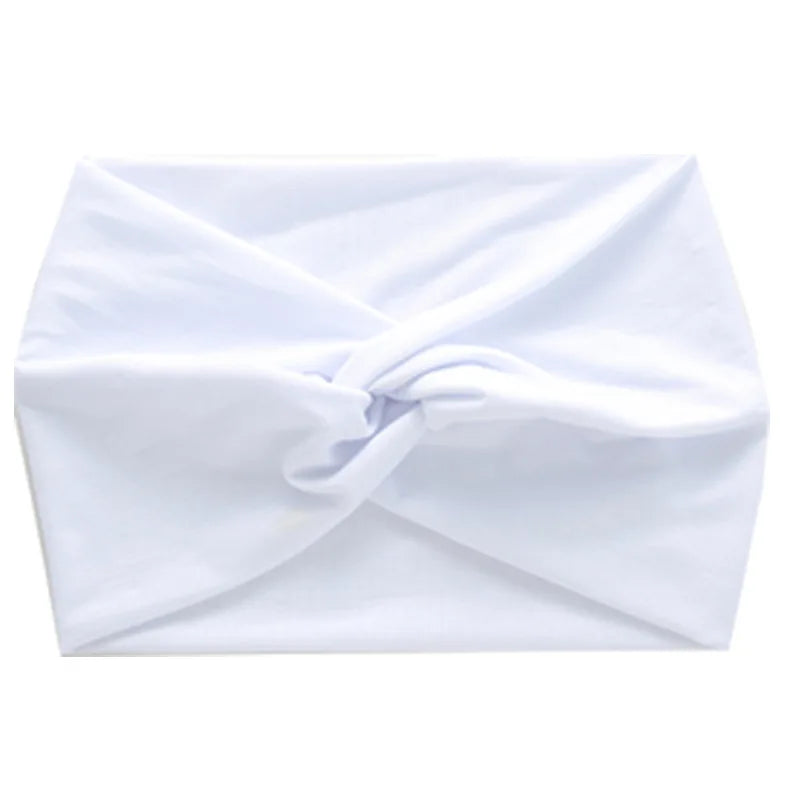 White women's elastic sports headband folded and displayed