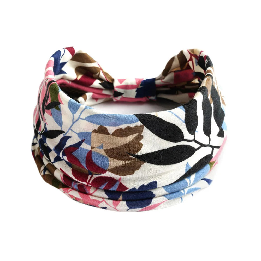 A close-up of a patterned bohemian cotton stretch headband tied in a bow.
