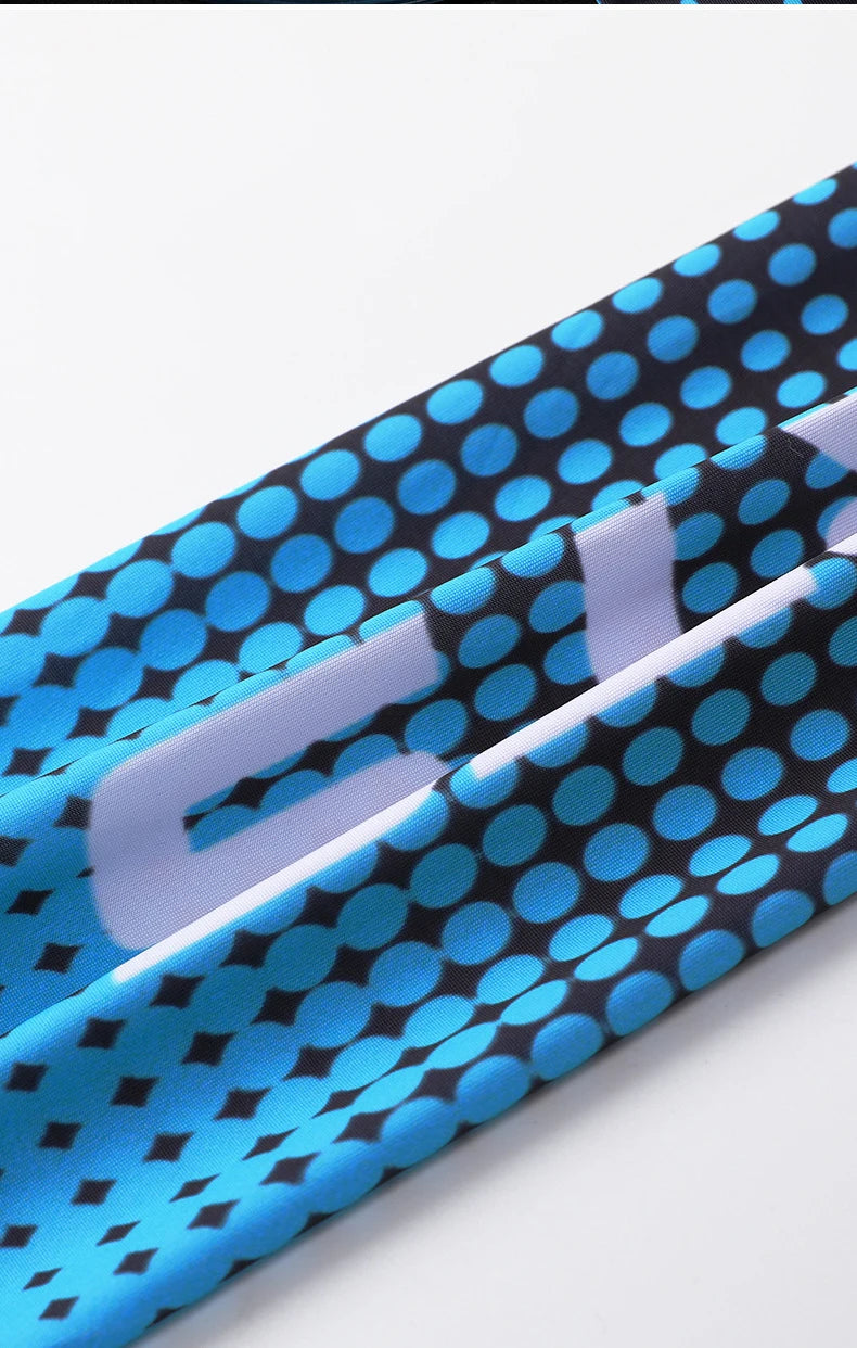 Close-up of a blue and black patterned fabric featuring white text on a sleeve or band.