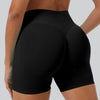 A close-up shot of a woman wearing black seamless high-waist yoga leggings.